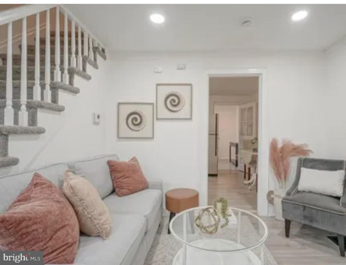 1069 Collings Road Camden, NJ 08104 - Photo 2 of 4 a living room with furniture and a painting
