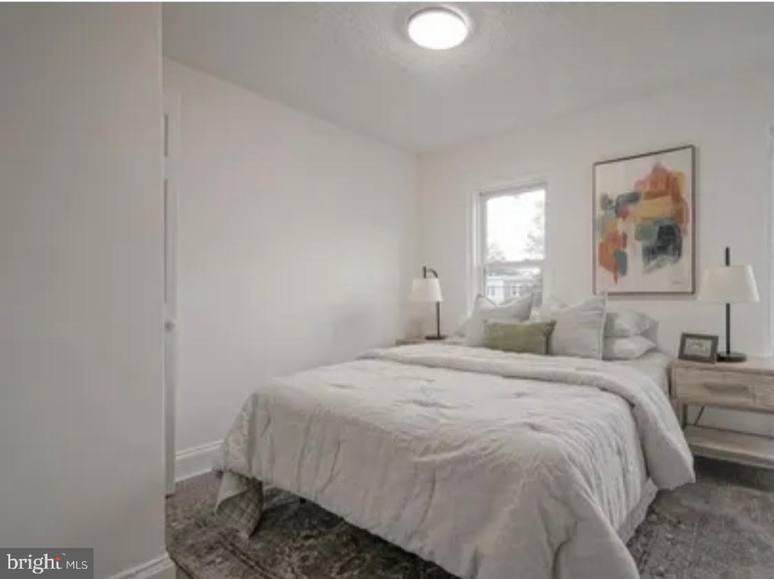 1069 Collings Road Camden, NJ 08104 - Photo 3 of 4 a bedroom with a bed and a window