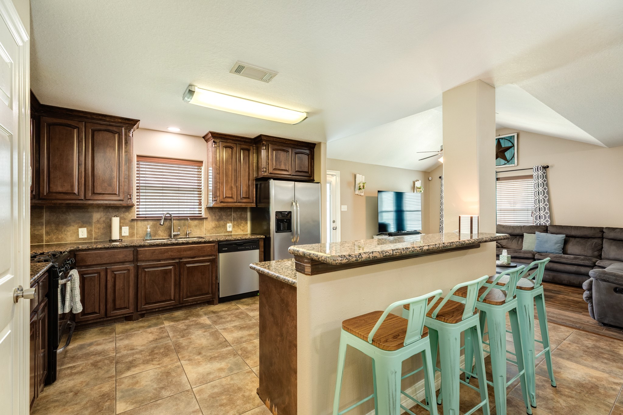 6108 Fox Ridge Drive Angleton, TX 77515 - Photo 10 of 26 a large kitchen with granite countertop a sink and stove