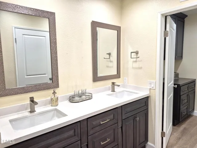 a bathroom with a sink double vanity and a mirror