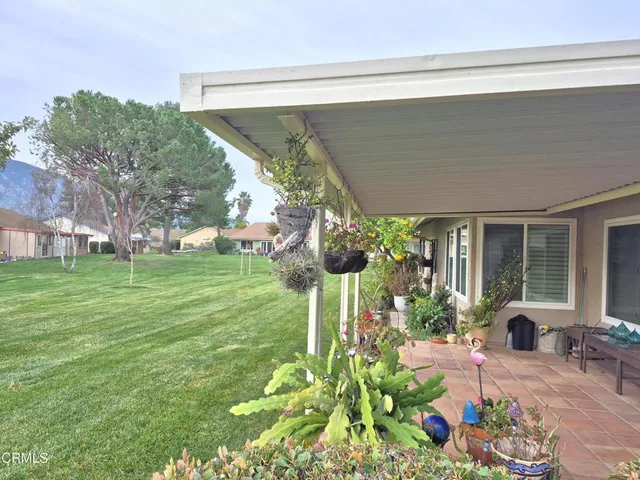 a backyard of a house with outdoor seating