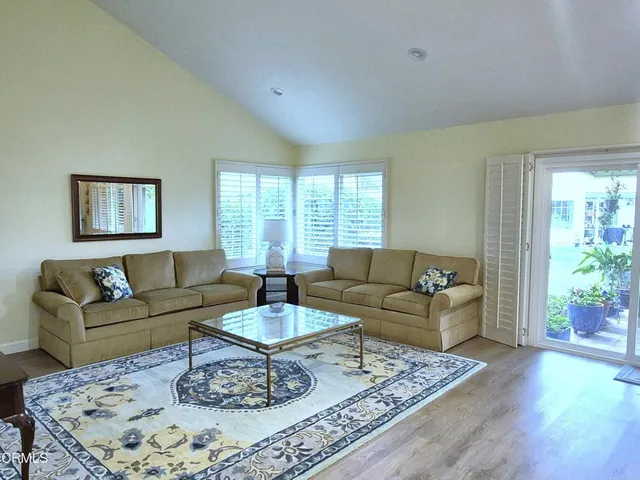 a living room with furniture and a rug
