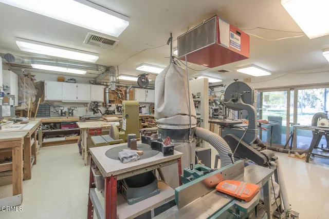 a living room with furniture a flat screen tv and a table