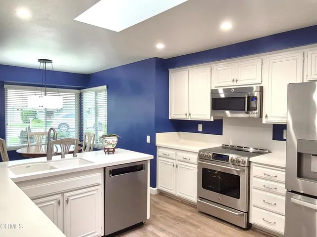 a kitchen with a sink stove and microwave