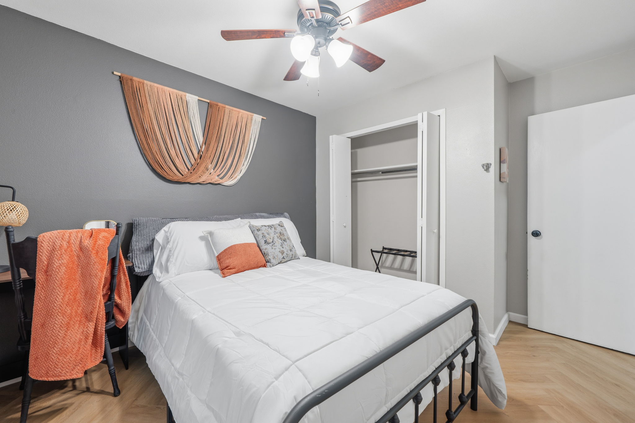 705 Dulwich Street Austin, TX 78748 - Photo 18 of 36 An inviting sleeping space with herringbone flooring and a practical closet system, offering comfort and convenience.