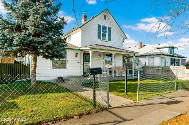 a view of a house with backyard and sitting area
