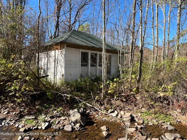 a view of a house with a small yard and plants