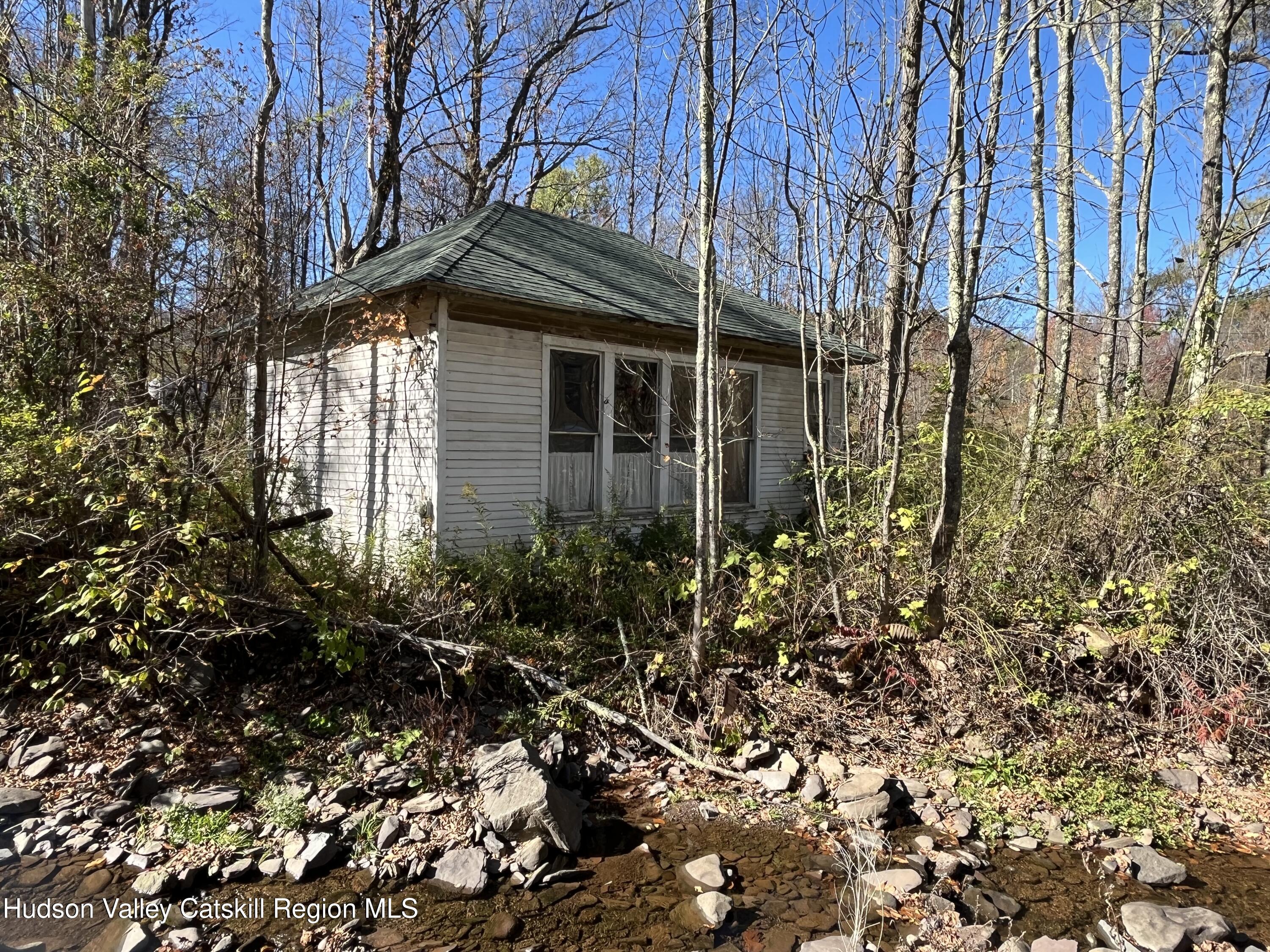 a view of a house with a small yard and plants