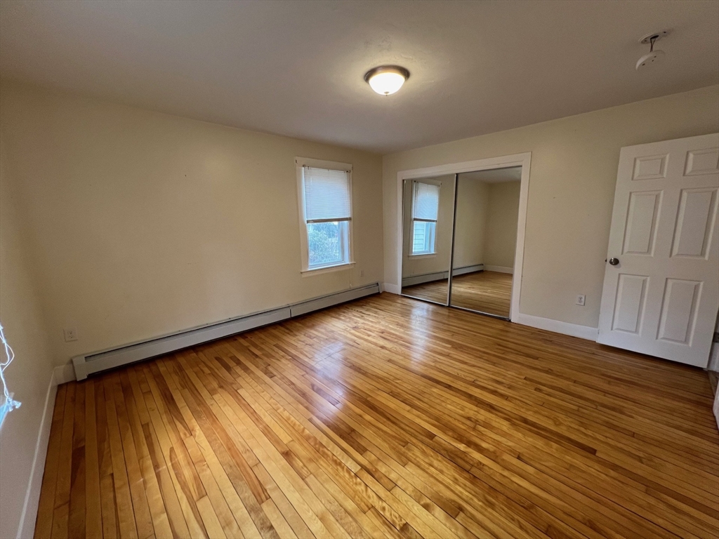 172 Chester Street Fitchburg, MA 01420 - Photo 6 of 22 a view of an empty room with wooden floor and a window