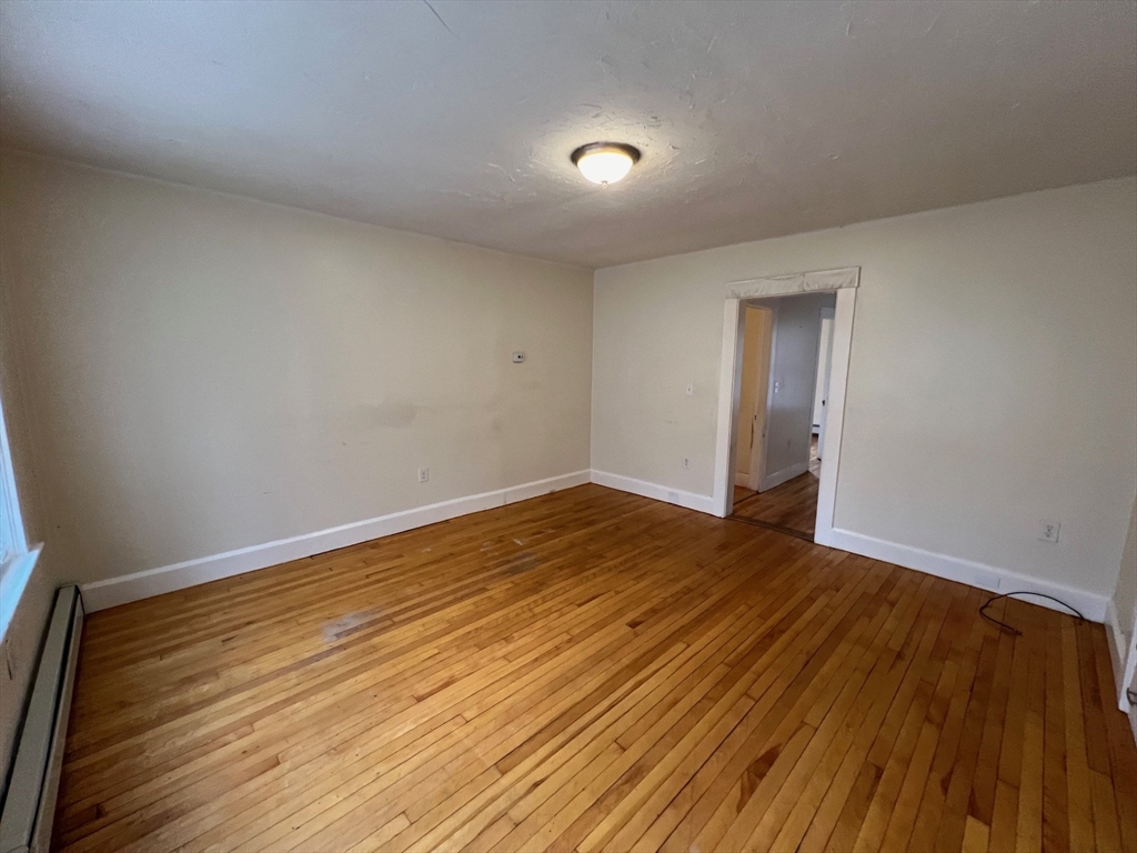 172 Chester Street Fitchburg, MA 01420 - Photo 7 of 22 a view of an empty room with wooden floor and closet