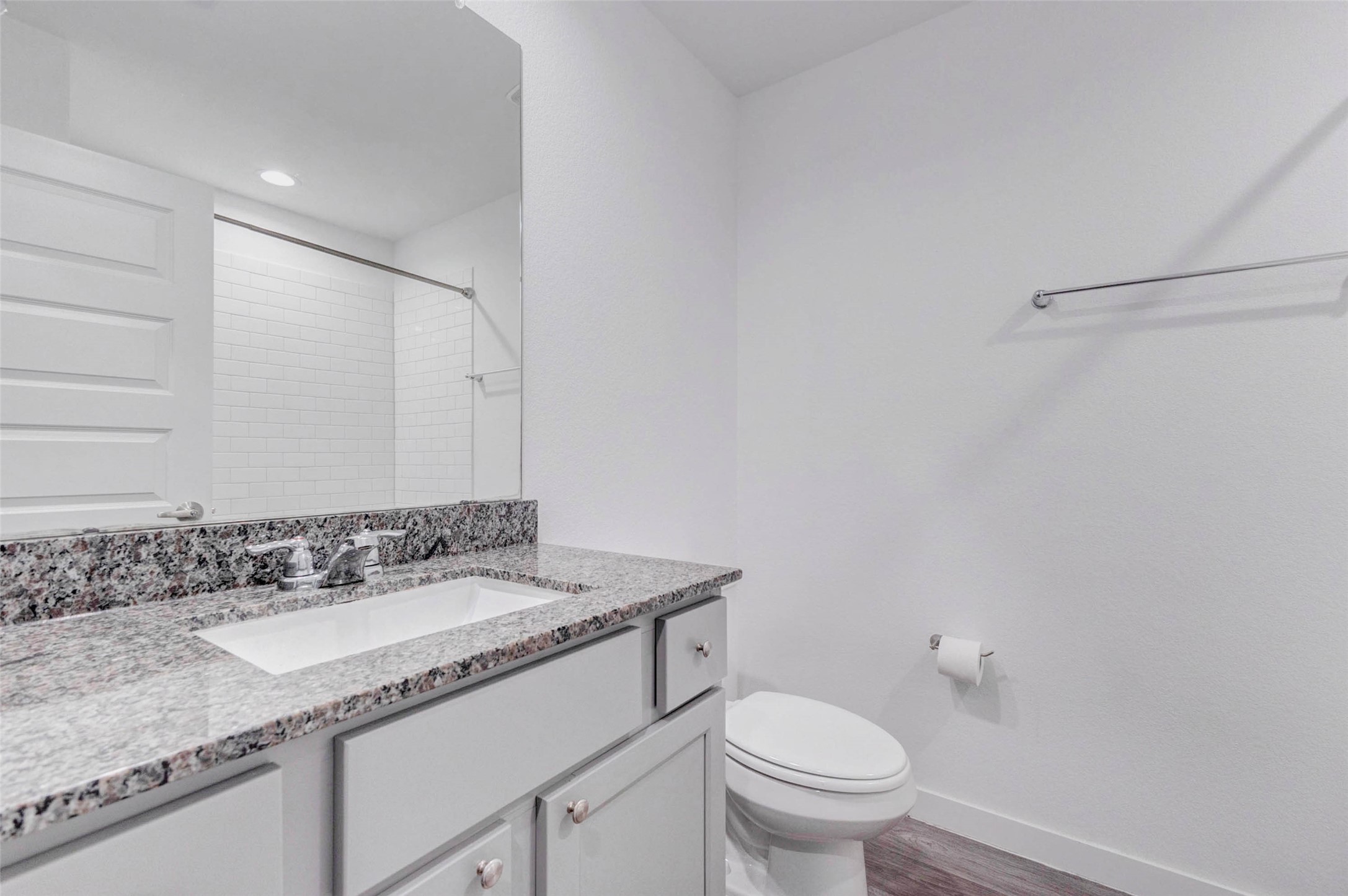3903 Beltingham Bend Way Fulshear, TX 77441 - Photo 17 of 27 a bathroom with a granite countertop sink a toilet and a mirror
