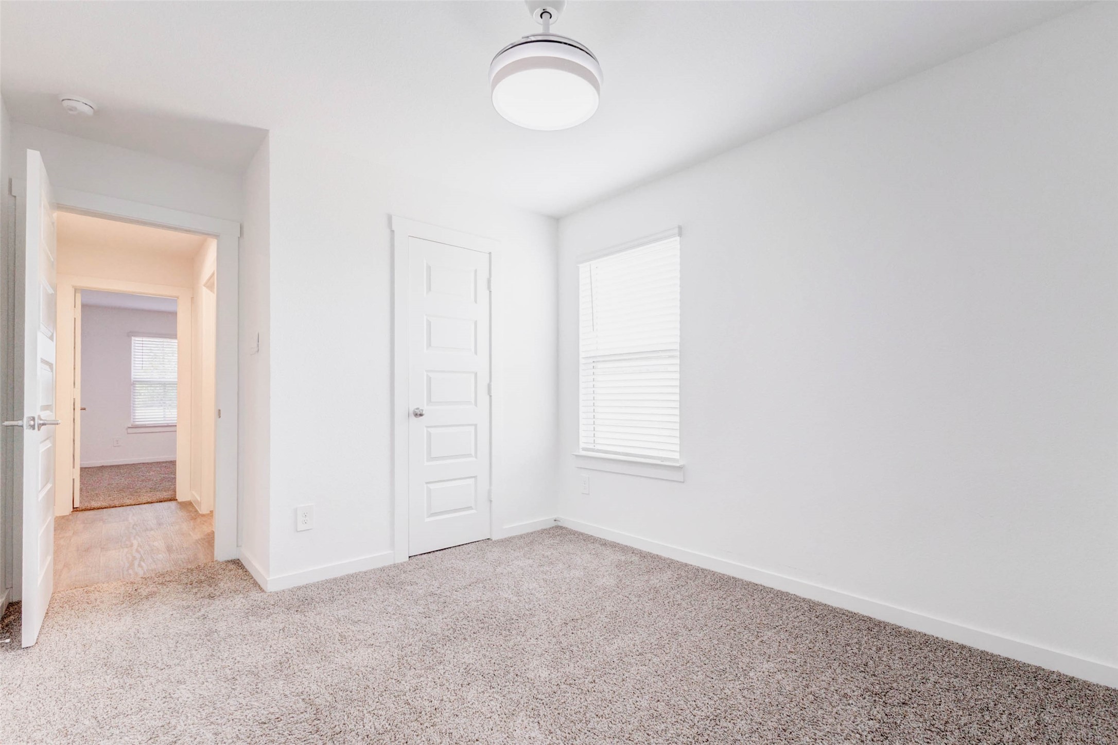 3903 Beltingham Bend Way Fulshear, TX 77441 - Photo 19 of 27 an empty room with windows and closet