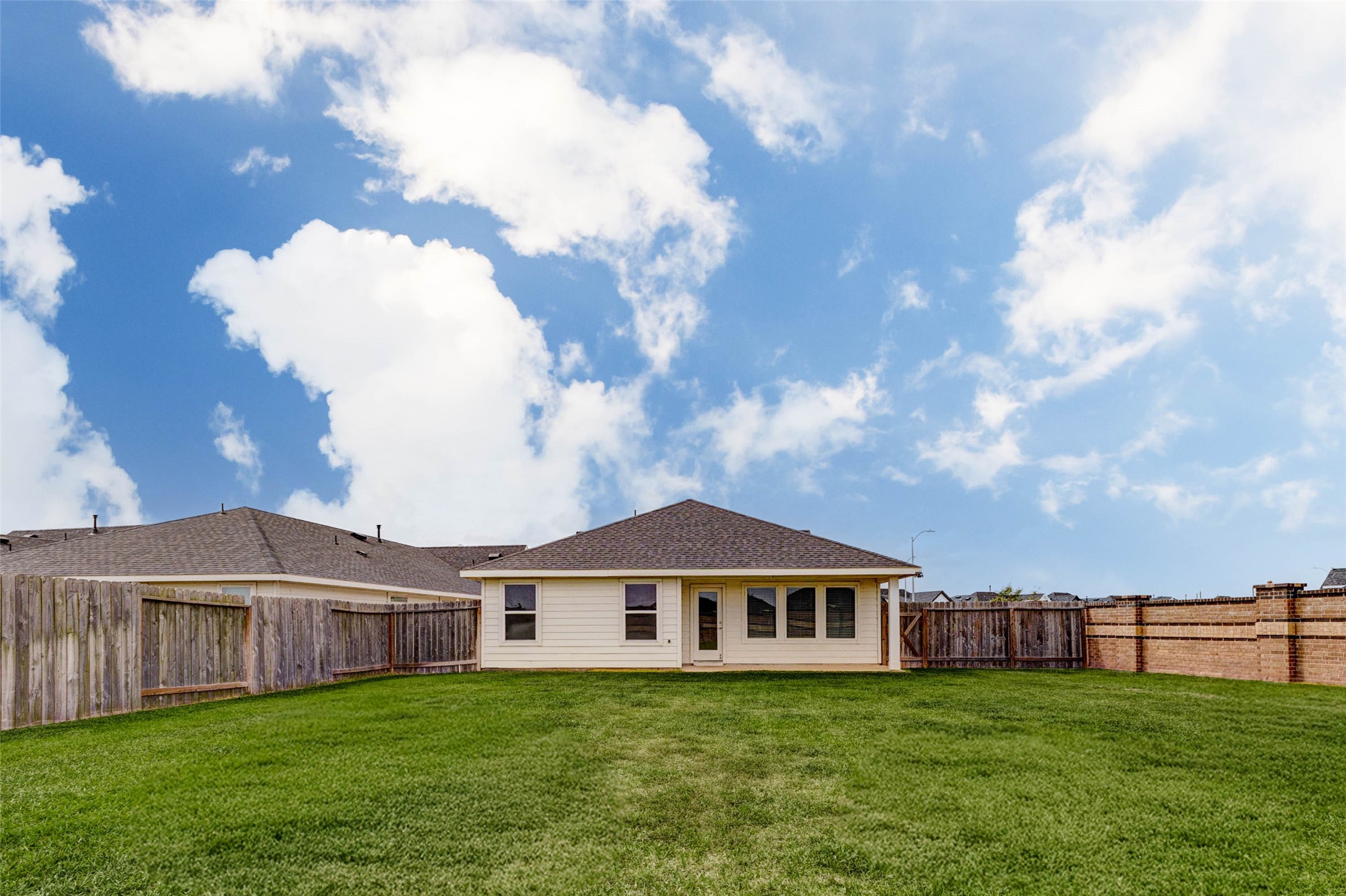 3903 Beltingham Bend Way Fulshear, TX 77441 - Photo 23 of 27 a view of a house with a yard and fence