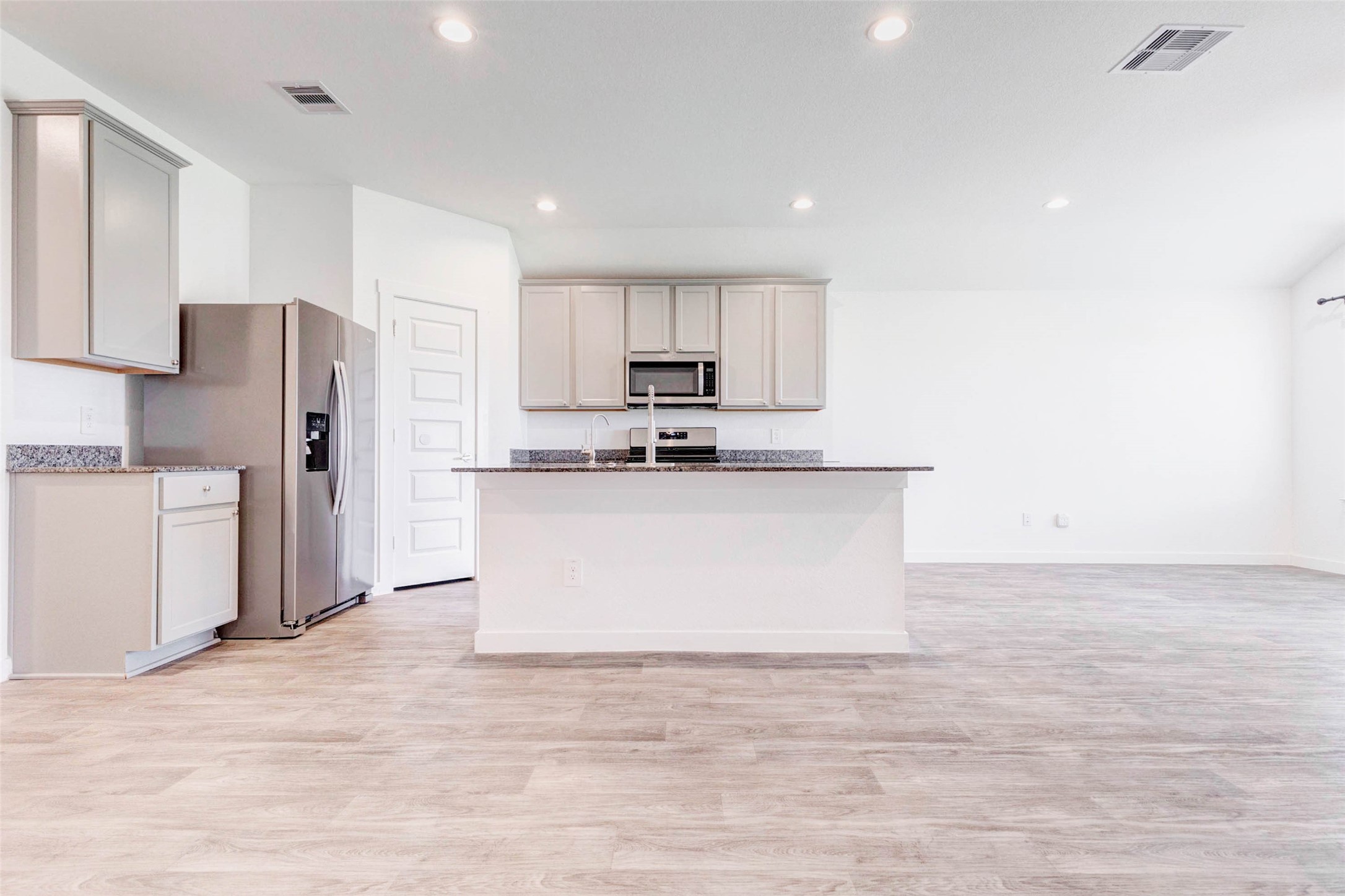 3903 Beltingham Bend Way Fulshear, TX 77441 - Photo 6 of 27 a view of kitchen with stainless steel appliances granite countertop white cabinets and refrigerator