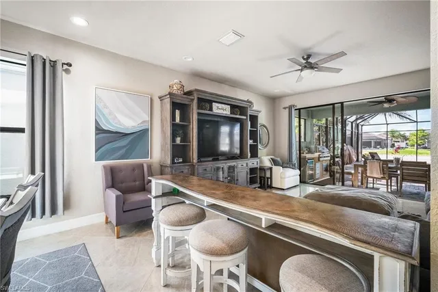 a room with furniture a flat screen tv and a large window