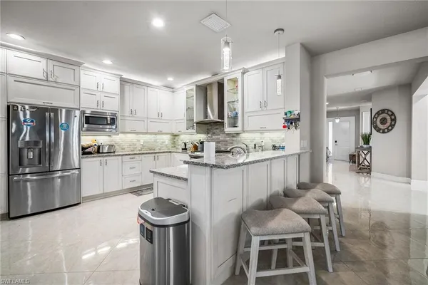 a kitchen with a sink cabinets and stainless steel appliances