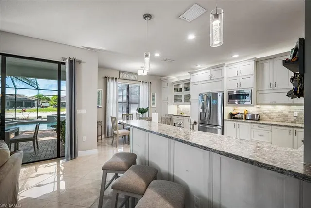 a large kitchen with granite countertop lots of counter space and window