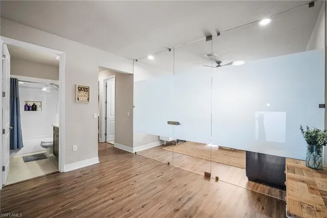 a view of a hallway with wooden floor and staircase
