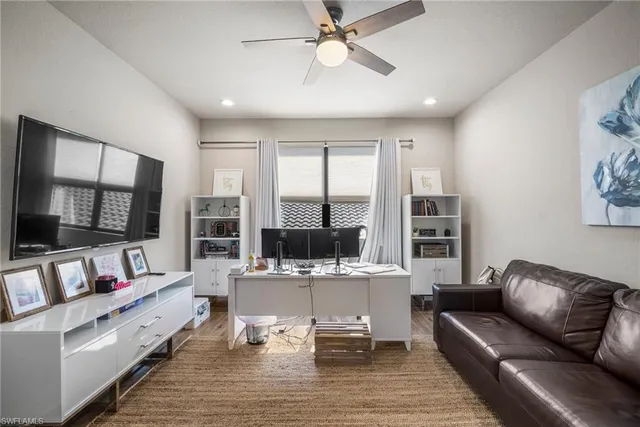 a bedroom with furniture and a large window