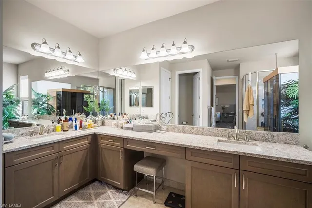 a bathroom with a shower and a glass door shower