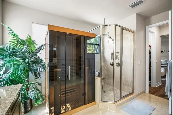 a bathroom with a granite countertop sink vanity mirror and toilet