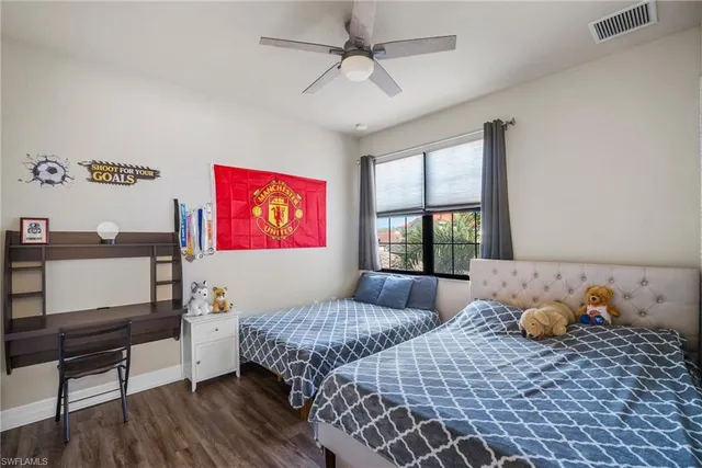 a bedroom with furniture and a wooden floor