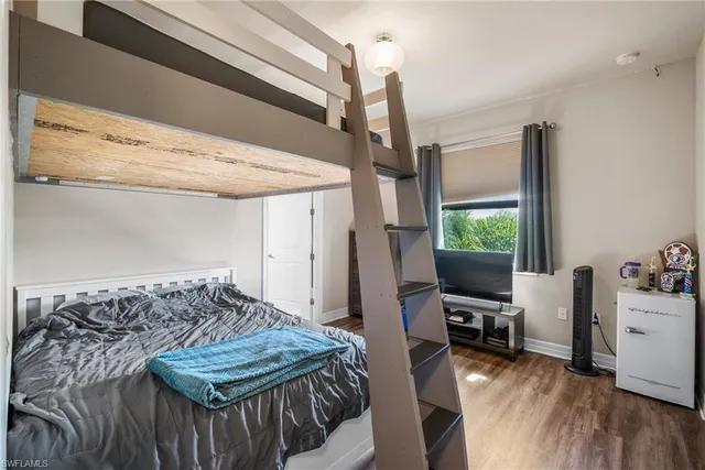 a bathroom with a granite countertop sink a toilet and a mirror