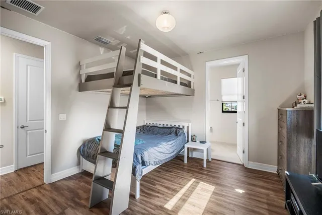 a bathroom with a granite countertop sink a toilet a mirror a vanity and shower