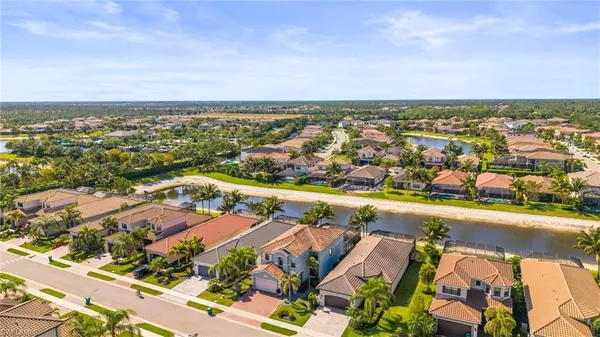 an aerial view of residential houses with outdoor space and swimming pool