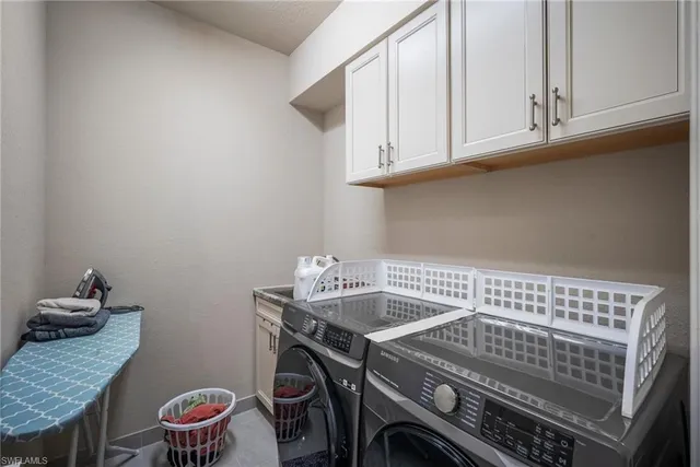 a view of a dining room with furniture a chandelier and wooden floor