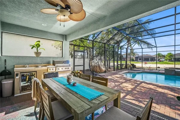 a view of a swimming pool with a patio and a yard