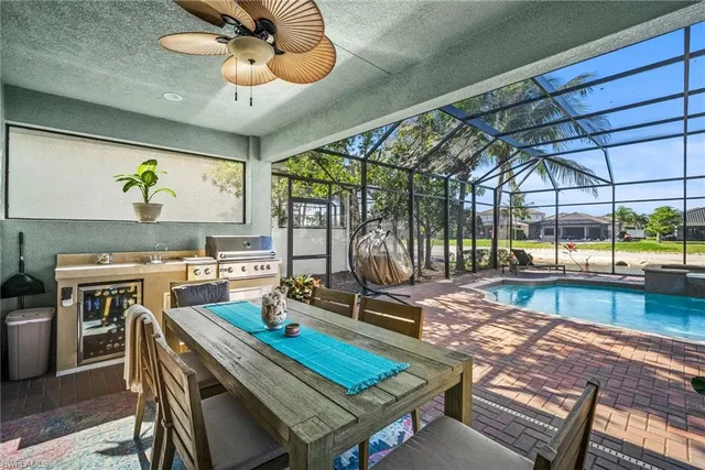 a view of a swimming pool with a patio and a yard