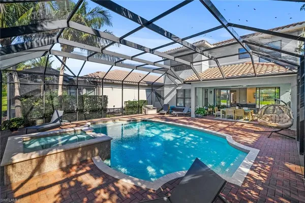 a swimming pool with outdoor seating and yard