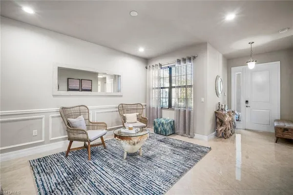 a living room with furniture a rug and a window