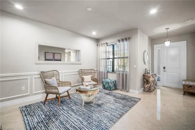 a living room with furniture a rug and a window