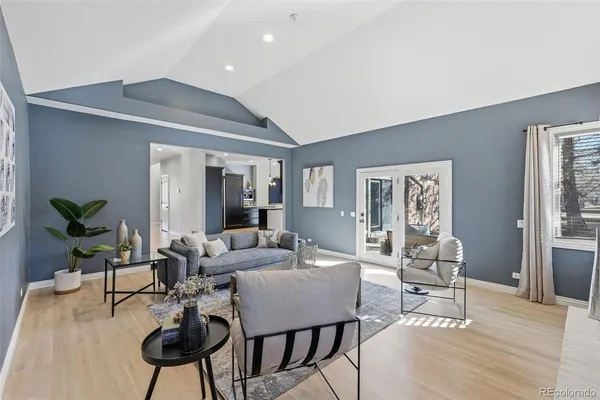 a living room with furniture and a potted plant