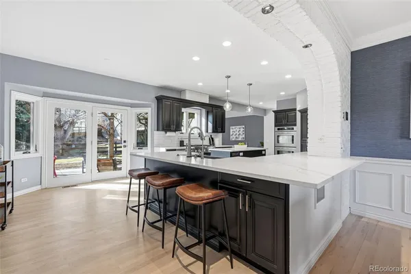a kitchen with a table chairs sink and cabinets