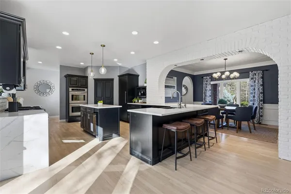 a large kitchen with a table and chairs