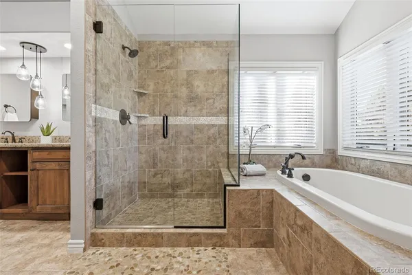a spacious bathroom with a bathtub and a shower