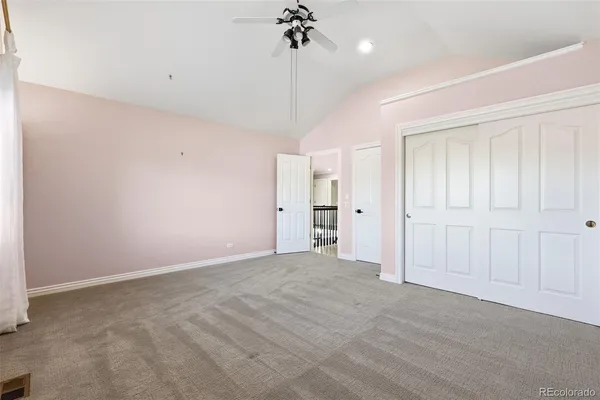 a view of a room with a ceiling fan and shower
