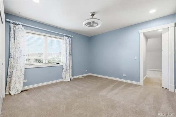 an empty room with windows and closet