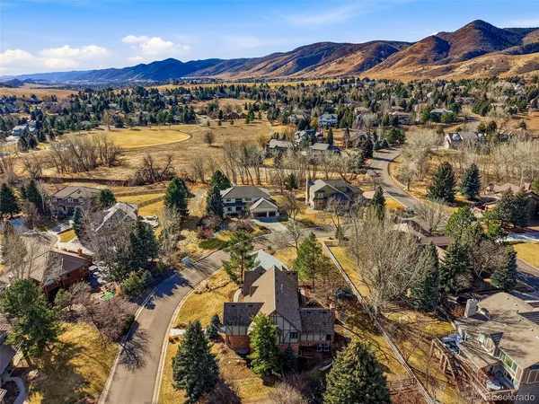 an aerial view of a house with swimming pool and mountain view