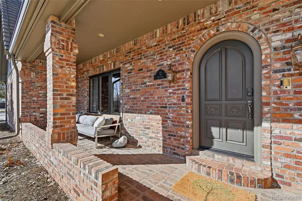 a view of a brick house with large windows
