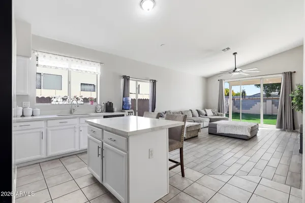 a kitchen with a sink dining table and chairs