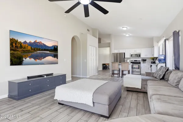 a living room with furniture and wooden floor