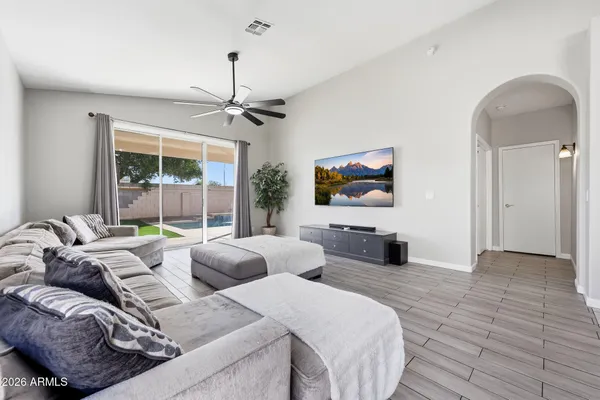 a living room with furniture ceiling fan and a window