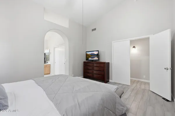 a bedroom with a bed and a dresser