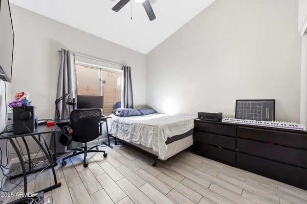 a bed room with a bed window and a chair