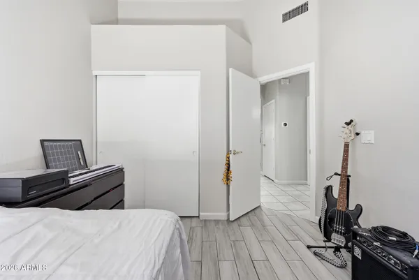 a bedroom with a bed and a wooden floor