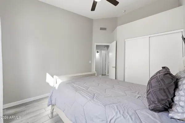 a bedroom with a bed and a mirror